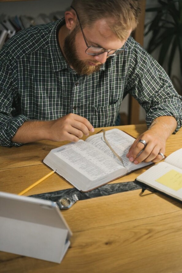 a bearded man reading a holy bible